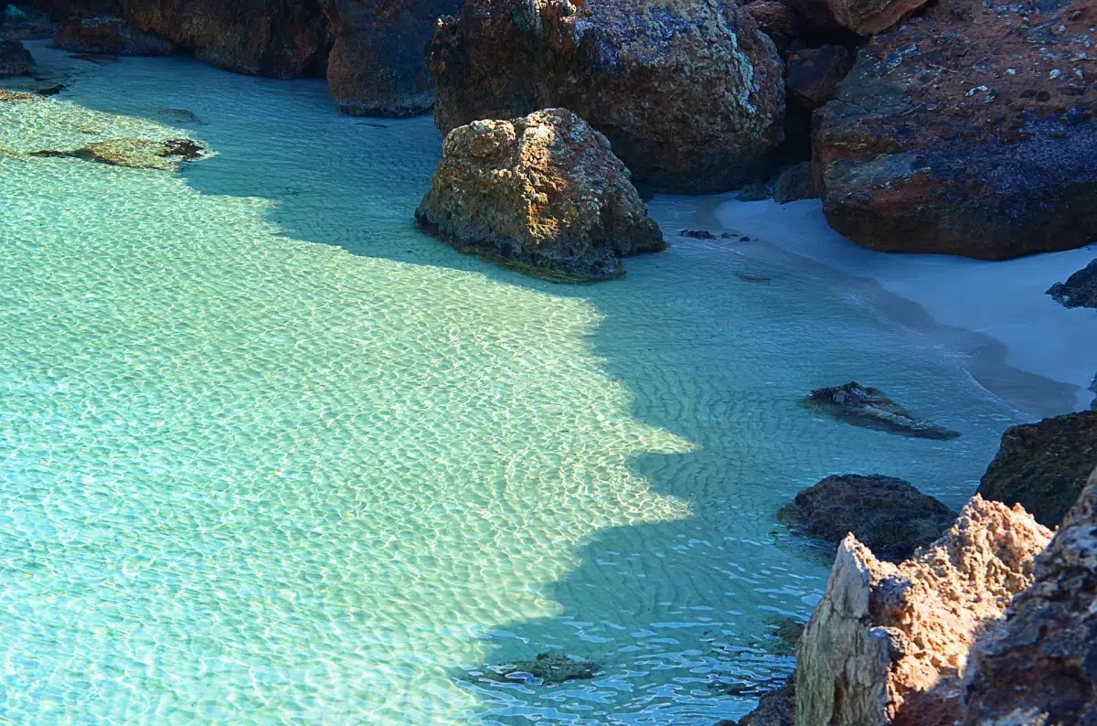 Enjoy the clear waters of Ibiza. Photo by wistaich via Pixabay.