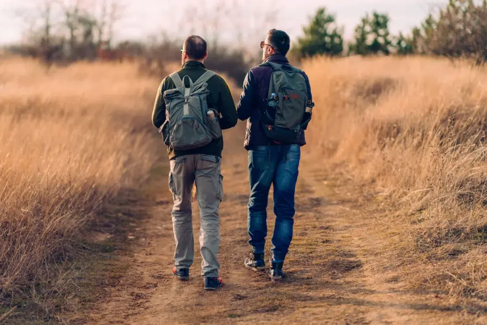 male couple hiking on a trail