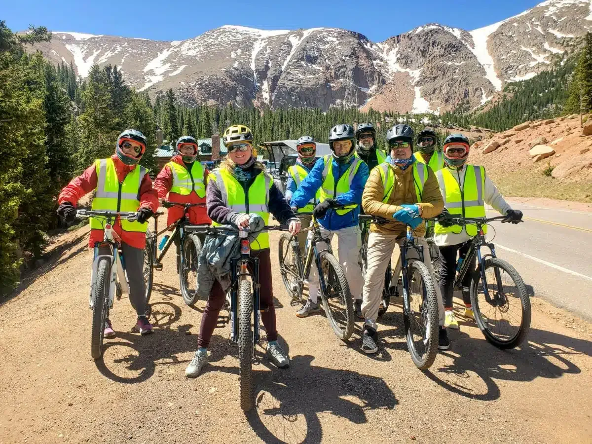 Author and group of bicyclists pose for a photo during a break on their bicycle ride down Pikes Peak.