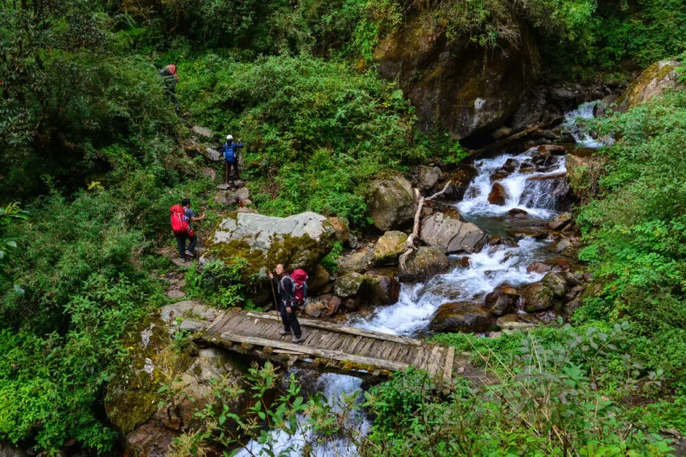 Trekkers with backpack walking on trail of Annapurna Circuit Trekking in Khopra, Nepal.