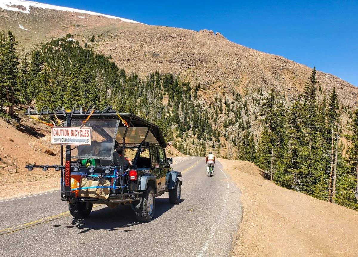 Adventures Out West vehicle stays with cyclists as they are bicycling Pikes Peak.