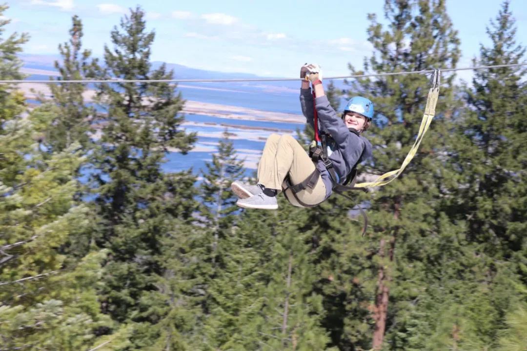 A client ziplining at Crater Lake Zipline